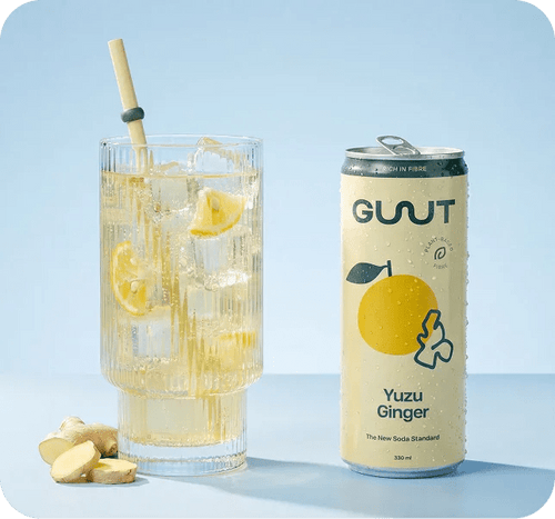 A glass of sparkling GUUT Yuzu Ginger prebiotic soda served over ice